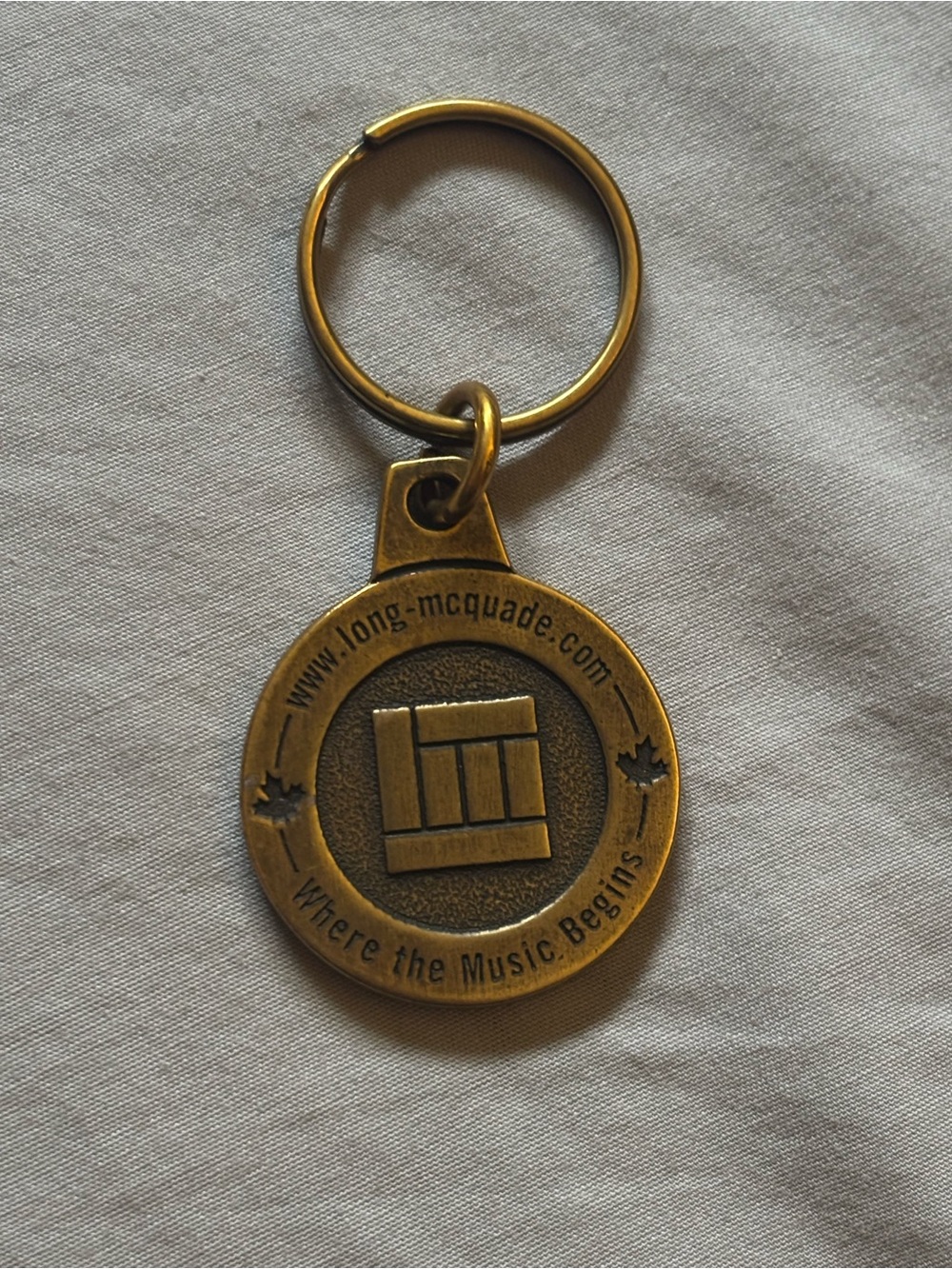 free w/purchase: gold/brass metal music keychain
